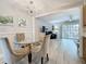 Bright dining room featuring a glass table, upholstered chairs, and views of the living area at 3620 41St S Way # B, St Petersburg, FL 33711