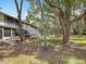 Exterior view of home featuring lawn, landscaping and surrounding trees at 3620 41St S Way # B, St Petersburg, FL 33711
