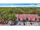 Condominium building with ample parking surrounded by lush greenery in a well-maintained community at 3620 41St S Way # B, St Petersburg, FL 33711