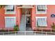 Condo building with stairs, railings, and muted pink facade at Bermuda Bay in St. Petersburg, Florida at 3620 41St S Way # B, St Petersburg, FL 33711