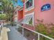 Exterior view of a muted pink condo building in Bermuda Bay with lush landscaping at 3620 41St S Way # B, St Petersburg, FL 33711