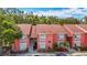 Two-story condominium building featuring shuttered windows, well-kept landscaping, and outdoor stairway at 3620 41St S Way # B, St Petersburg, FL 33711