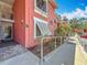 Exterior view of a muted pink condo in Bermuda Bay with walkway, white railings, and shutters at 3620 41St S Way # B, St Petersburg, FL 33711