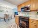 Partial view of a kitchen with modern appliances and connection to the dining area at 3620 41St S Way # B, St Petersburg, FL 33711
