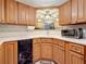 Efficient kitchen space with wooden cabinetry, black dishwasher, and bright countertop with a sink at 3620 41St S Way # B, St Petersburg, FL 33711