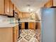 Functional kitchen with wooden cabinets, black appliances, and bright countertops at 3620 41St S Way # B, St Petersburg, FL 33711