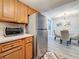 Modern kitchen with wooden cabinetry and stainless steel refrigerator, connected to the dining area at 3620 41St S Way # B, St Petersburg, FL 33711