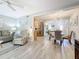 Bright, open-concept living room featuring hard surface floors, dining area, and neutral paint palette at 3620 41St S Way # B, St Petersburg, FL 33711