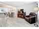 Living room featuring hard surface floors, comfortable seating, and views into dining area at 3620 41St S Way # B, St Petersburg, FL 33711