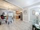 Open floor plan with living, dining, and kitchen areas featuring plank flooring and neutral tones at 3620 41St S Way # B, St Petersburg, FL 33711