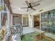 Spacious screened in lanai with ceiling fan, outdoor seating, and view to interior at 3620 41St S Way # B, St Petersburg, FL 33711