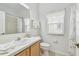 Bright bathroom featuring a vanity with sink, tile flooring, and a window for natural light at 3762 Darston St, Palm Harbor, FL 34685