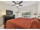 Relaxing main bedroom with a ceiling fan, closet, and view of the outdoor hot tub, creating a peaceful retreat at 3762 Darston St, Palm Harbor, FL 34685