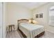 Cozy bedroom with wood flooring, a bed, and natural light from the window at 3762 Darston St, Palm Harbor, FL 34685