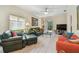 Cozy living room features wood floors, neutral walls, a ceiling fan and sliding doors that let in natural light at 3762 Darston St, Palm Harbor, FL 34685