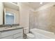 A bathroom featuring a granite countertop, tile shower/tub, and neutral walls at 3860 Obsidian Dr, Spring Hill, FL 34609