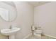 A clean bathroom featuring a pedestal sink, tile floors, and neutral walls at 3860 Obsidian Dr, Spring Hill, FL 34609
