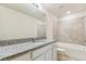 A bathroom featuring a granite countertop, tile shower/tub, and neutral walls at 3860 Obsidian Dr, Spring Hill, FL 34609