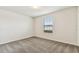 A well-lit bedroom features neutral walls, carpeted floors, and a window at 3860 Obsidian Dr, Spring Hill, FL 34609