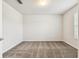 A clean bedroom featuring neutral walls, carpet floors, and window allowing natural light to fill the space at 3860 Obsidian Dr, Spring Hill, FL 34609