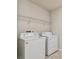 Efficient laundry room with washer, dryer, and overhead shelving for organized storage and convenience at 3860 Obsidian Dr, Spring Hill, FL 34609
