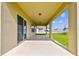 Covered patio space perfect for outdoor entertaining, overlooking a well-manicured lawn and neighborhood views at 3860 Obsidian Dr, Spring Hill, FL 34609
