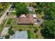 Aerial view of home with a spacious yard, deck, covered patio, and mature trees at 39542 Friends Ave, Zephyrhills, FL 33540