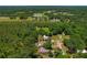 Aerial view of the property with a backdrop of a lush forest at 39542 Friends Ave, Zephyrhills, FL 33540