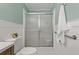 Bathroom featuring a white toilet and shower stall, accented by light green walls at 39542 Friends Ave, Zephyrhills, FL 33540