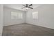 Spacious bedroom with neutral carpet, natural light from the windows, and a ceiling fan at 39542 Friends Ave, Zephyrhills, FL 33540