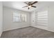 The bedroom boasts a ceiling fan, neutral carpet, and ample natural light from a window at 39542 Friends Ave, Zephyrhills, FL 33540