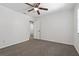 Bedroom featuring a ceiling fan, plush carpeting, and an open doorway to an adjoining room at 39542 Friends Ave, Zephyrhills, FL 33540