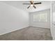 Bedroom featuring neutral carpet, a ceiling fan, and natural light from the window at 39542 Friends Ave, Zephyrhills, FL 33540
