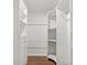 Walk-in closet with built-in shelving and drawers offers ample storage space at 39542 Friends Ave, Zephyrhills, FL 33540