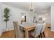 Elegant dining room with a modern chandelier, and a view of the kitchen, perfect for Gathering meals and entertaining guests at 39542 Friends Ave, Zephyrhills, FL 33540