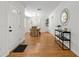 Inviting entryway with hardwood floors and stylish decor, leading to the dining area, showcasing a modern aesthetic at 39542 Friends Ave, Zephyrhills, FL 33540