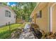 Charming home with a fenced yard, walkway, and lush landscaping at 39542 Friends Ave, Zephyrhills, FL 33540