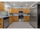 Modern kitchen with stainless steel appliances, light countertops, and ample cabinet space, designed for culinary enthusiasts at 39542 Friends Ave, Zephyrhills, FL 33540