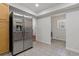 Spacious laundry area with a stainless steel refrigerator, and washer and dryer hookups, providing convenience and functionality at 39542 Friends Ave, Zephyrhills, FL 33540