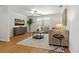 Cozy living room with wood floors, contemporary furniture, ceiling fan and bright window at 39542 Friends Ave, Zephyrhills, FL 33540