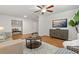 Bright living room with ceiling fan, attractive flooring, built-in storage, and a wall-mounted television at 39542 Friends Ave, Zephyrhills, FL 33540