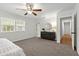 Spacious main bedroom with carpet flooring, a ceiling fan, and a view into the hallway at 39542 Friends Ave, Zephyrhills, FL 33540