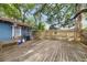 Backyard wooden deck with a gas grill, seating, and wooden railing for easy outdoor living and relaxation at 4016 N Seminole Ave, Tampa, FL 33603