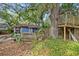 Exterior view of a deck, a large tree and a backyard tree house with a platform, and lots of foliage at 4016 N Seminole Ave, Tampa, FL 33603