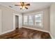 Bright bedroom features hardwood floors, ceiling fan, and natural light through large windows at 4016 N Seminole Ave, Tampa, FL 33603