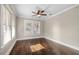 This bedroom has hardwood floors, crown molding, and large windows for lots of natural light at 4016 N Seminole Ave, Tampa, FL 33603