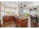 Open kitchen featuring granite countertops, stainless appliances, and breakfast bar overlooking the dining room at 4016 N Seminole Ave, Tampa, FL 33603