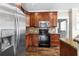 Modern kitchen with stainless steel appliances, granite countertops, and wood cabinetry at 4016 N Seminole Ave, Tampa, FL 33603