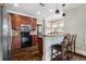 Modern kitchen with stainless steel appliances, granite countertops, and hardwood floors at 4016 N Seminole Ave, Tampa, FL 33603