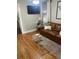 Inviting living room features hardwood floors and comfortable leather sofa at 4016 N Seminole Ave, Tampa, FL 33603